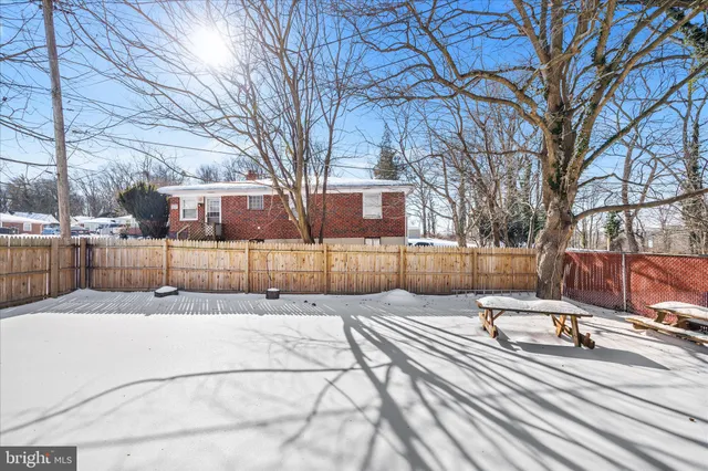 a view of a yard with snow on the road