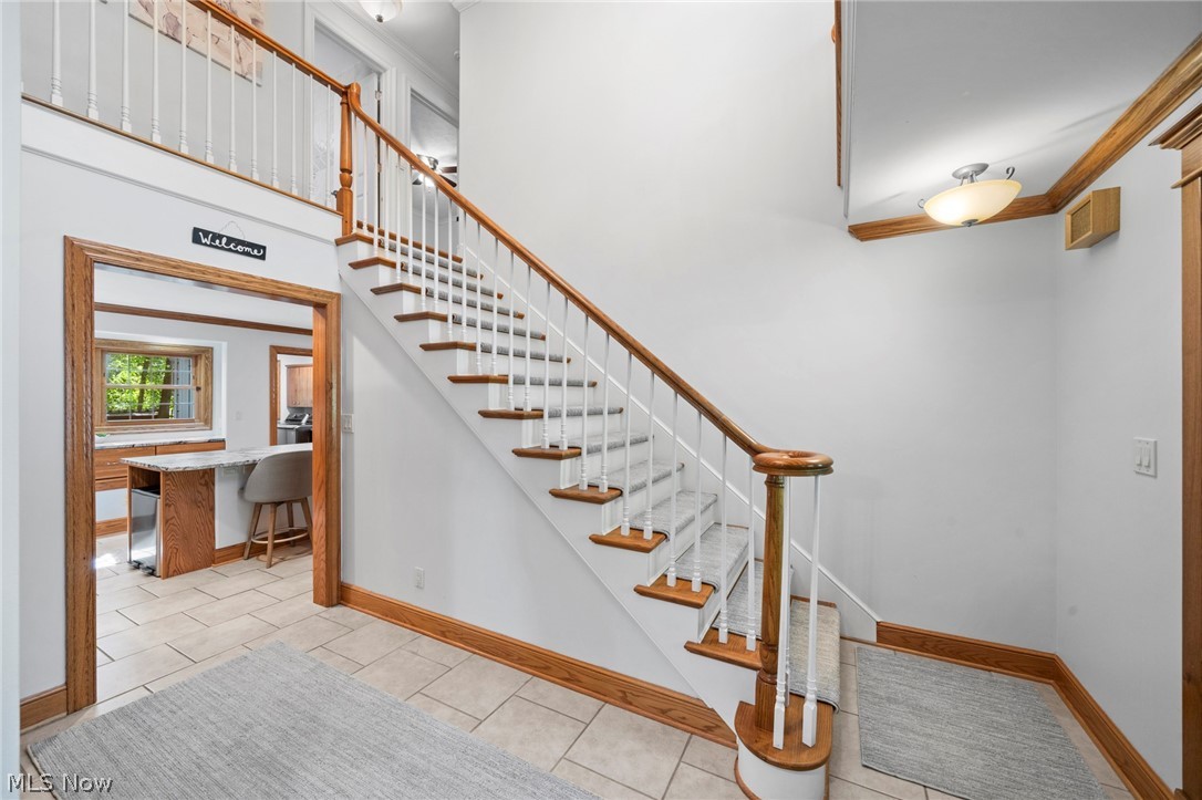 3871 Greentree Road Stow, OH 44224 - Photo 9 of 50 Foyer featuring a grand staircase with wood-finish handrails and white balusters