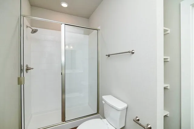 a bathroom with a shower and a toilet