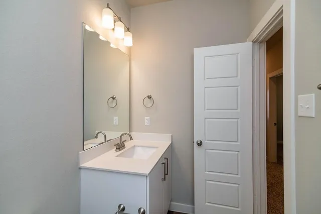 a bathroom with a sink and a mirror