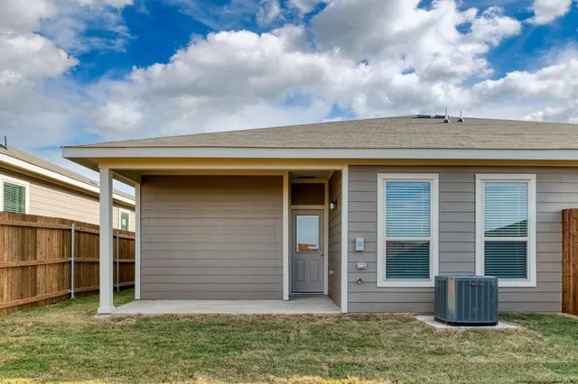 a view of house with backyard space