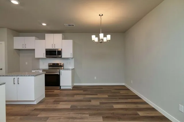 a view of a kitchen with microwave and stove