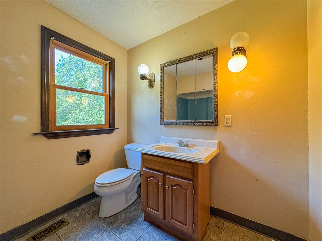 198 Union Road Wales, MA 01081 - Photo 13 of 42 a bathroom with a toilet a sink and a mirror