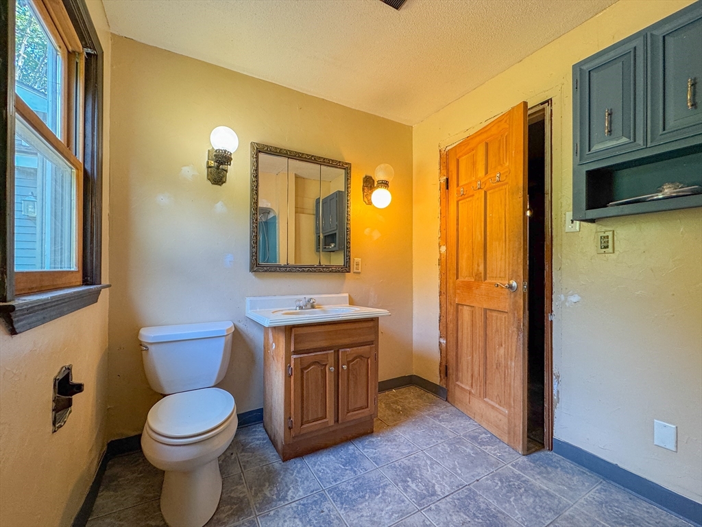 198 Union Road Wales, MA 01081 - Photo 14 of 42 a bathroom with a toilet a sink and mirror