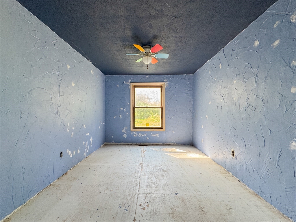 198 Union Road Wales, MA 01081 - Photo 18 of 42 an empty room with windows and fan