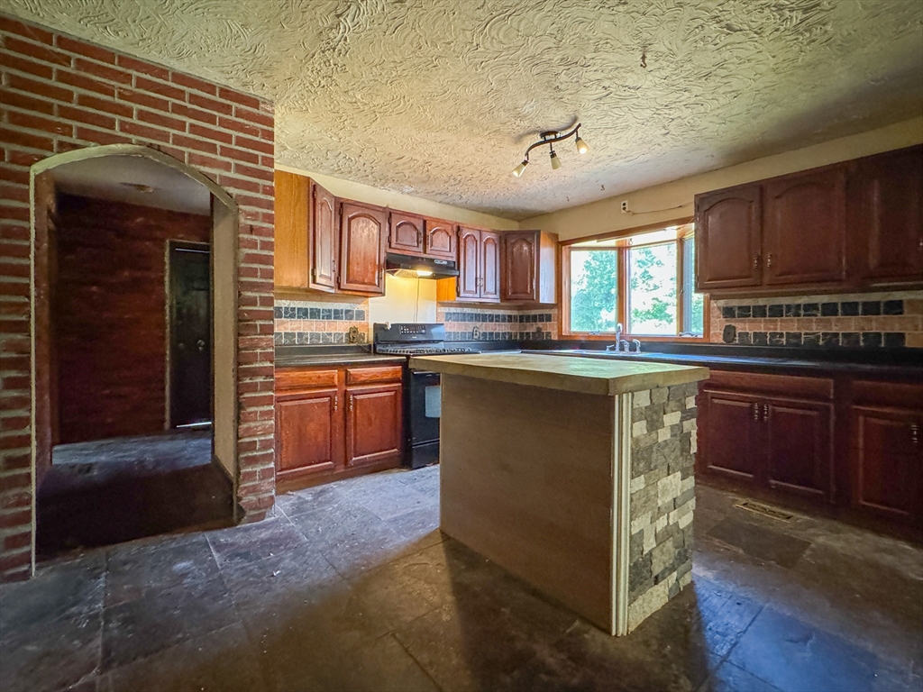 198 Union Road Wales, MA 01081 - Photo 21 of 42 a kitchen with stainless steel appliances granite countertop a stove sink and cabinets