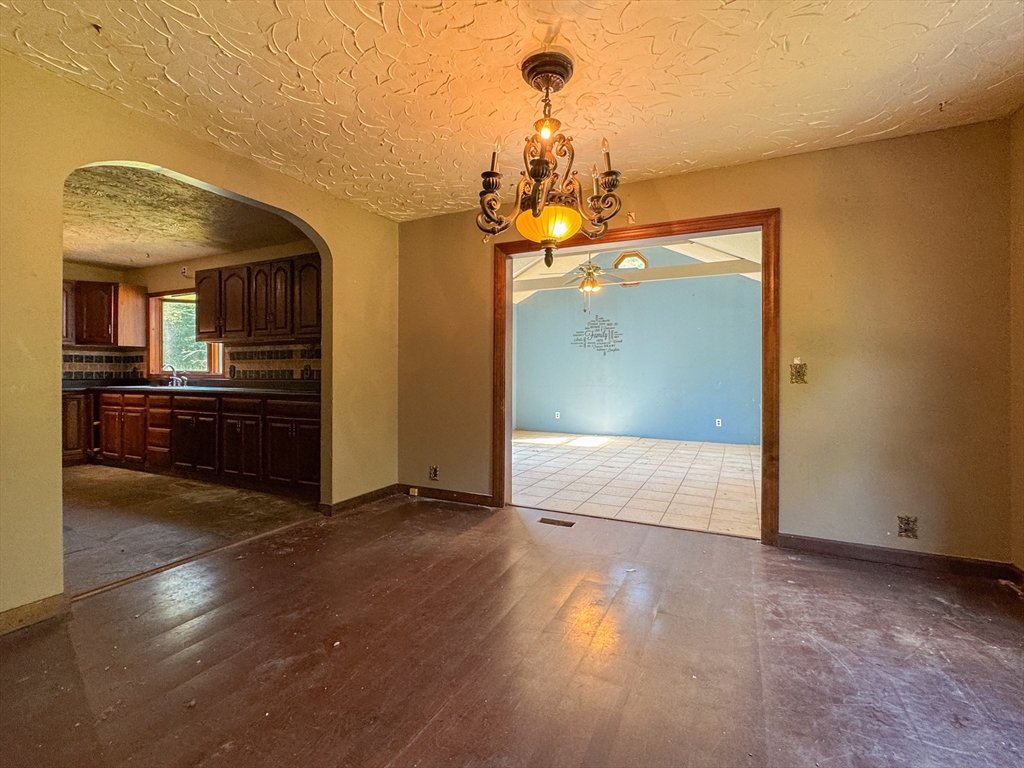 198 Union Road Wales, MA 01081 - Photo 24 of 42 a view of a hallway with wooden floor and chandelier