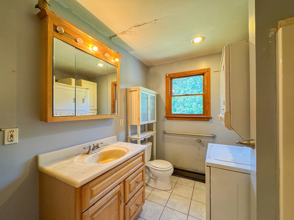 198 Union Road Wales, MA 01081 - Photo 32 of 42 a bathroom with a sink toilet and mirror