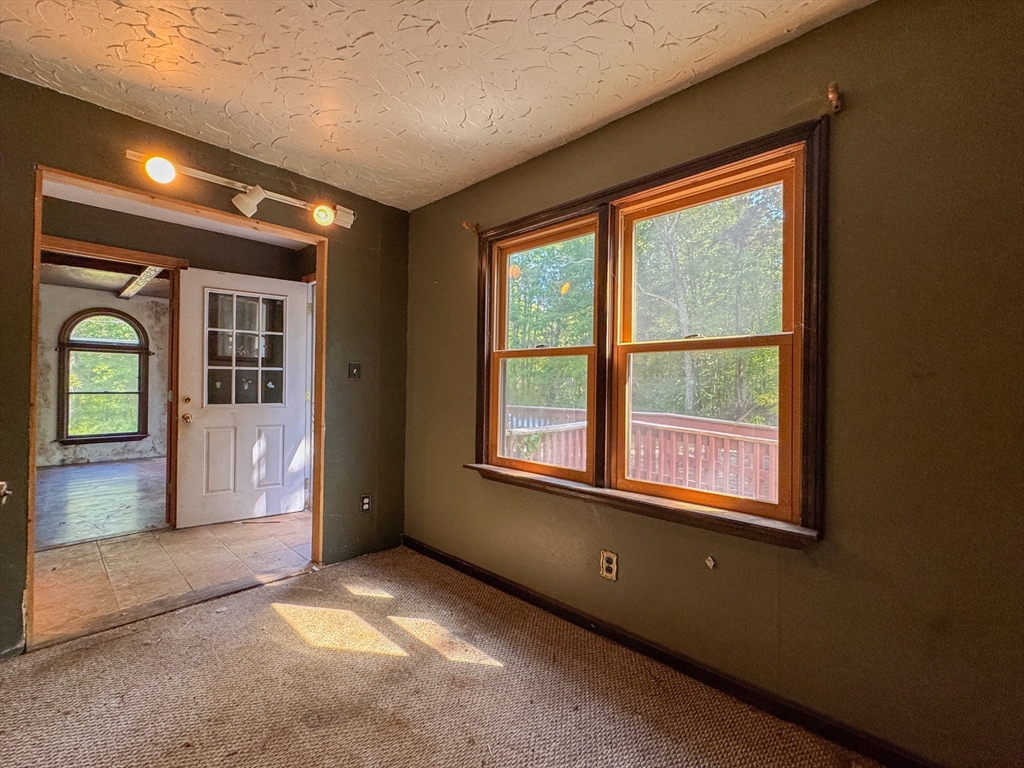 198 Union Road Wales, MA 01081 - Photo 42 of 42 an empty room with a fireplace and windows