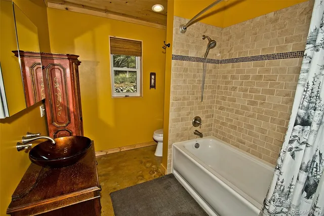 a bathroom with a bathtub and shower