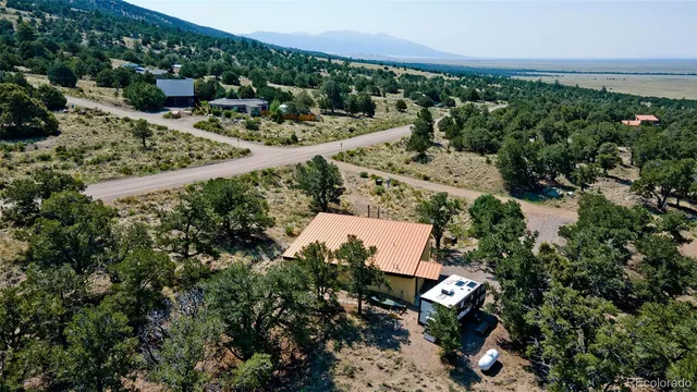 an aerial view of a house with a yard