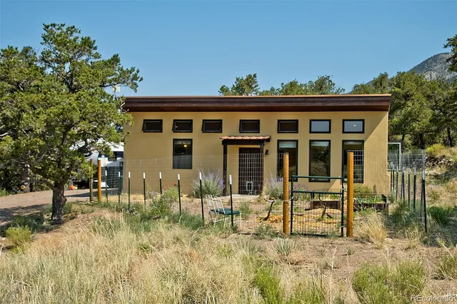 a backyard of a house with table and chairs