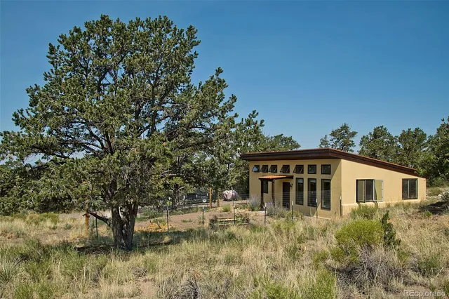 a view of house with yard and sitting area