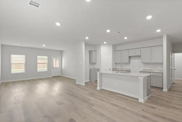 a view of kitchen with wooden floor and windows