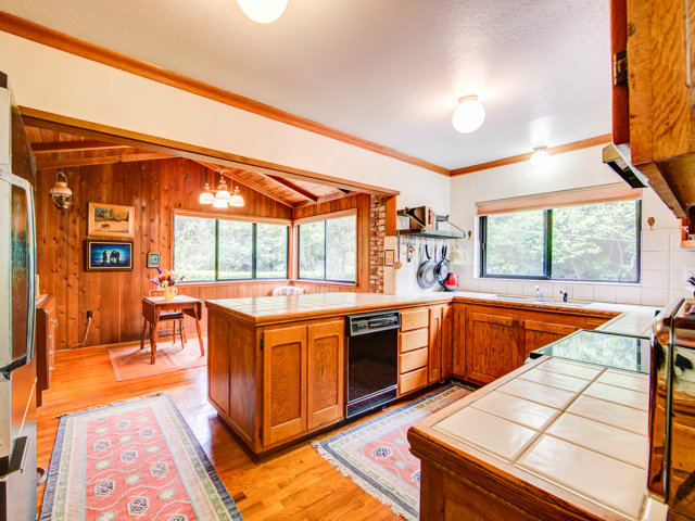 Undisclosed Address Soquel, CA 95073 - Photo 19 of 25 a large kitchen with stainless steel appliances granite countertop a sink and wooden cabinets