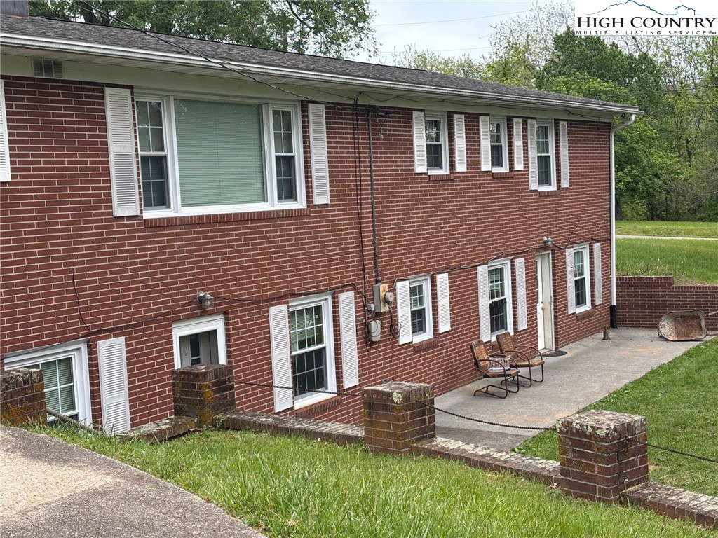 94 Kemp Street Sparta, NC 28675 - Photo 23 of 27 a front view of house with yard and patio