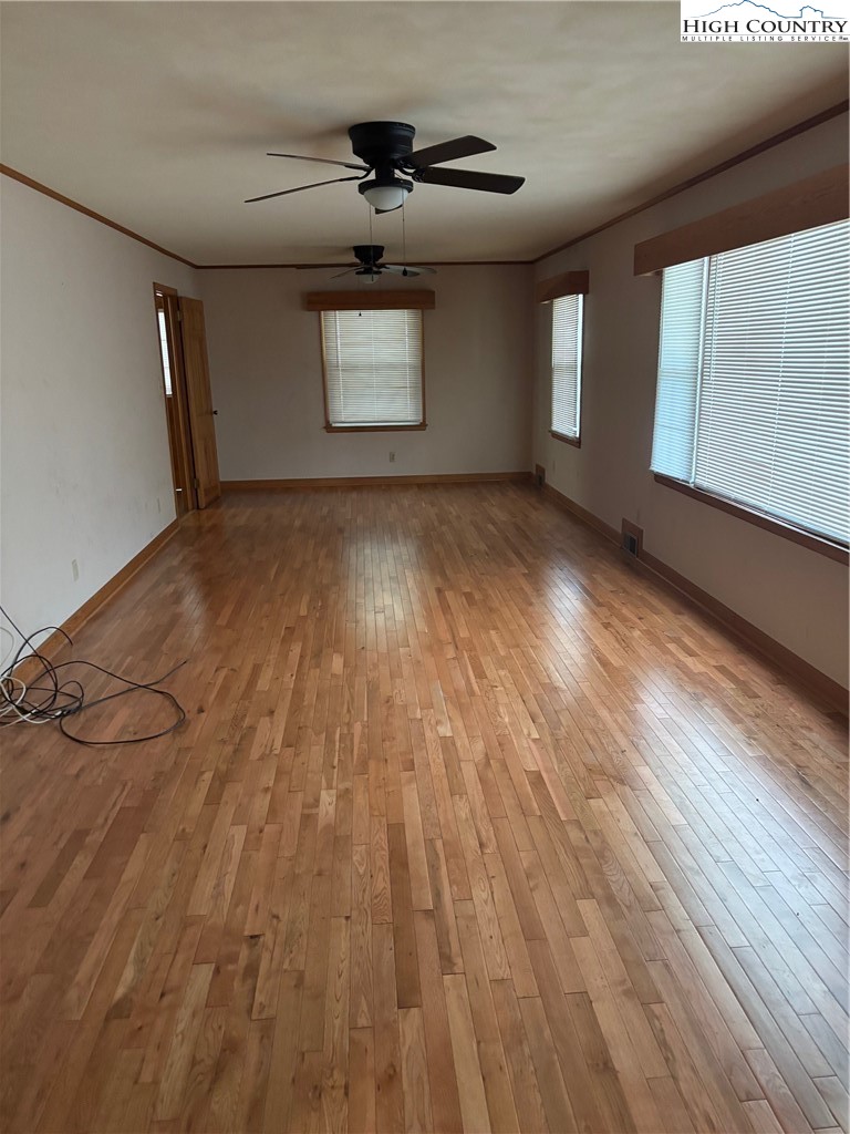 94 Kemp Street Sparta, NC 28675 - Photo 8 of 27 a view of empty room with wooden floor and fan