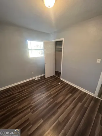a view of room with wooden floor and window