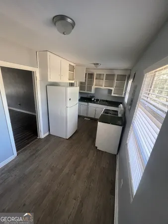 a kitchen with refrigerator and window