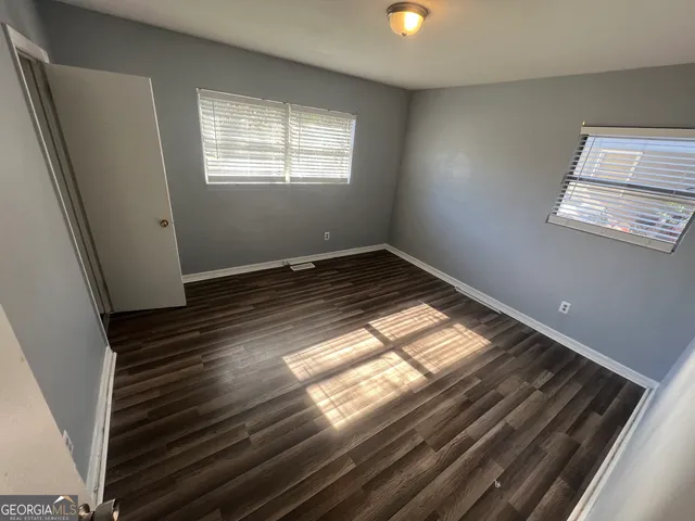 a view of wooden floor and windows in a room