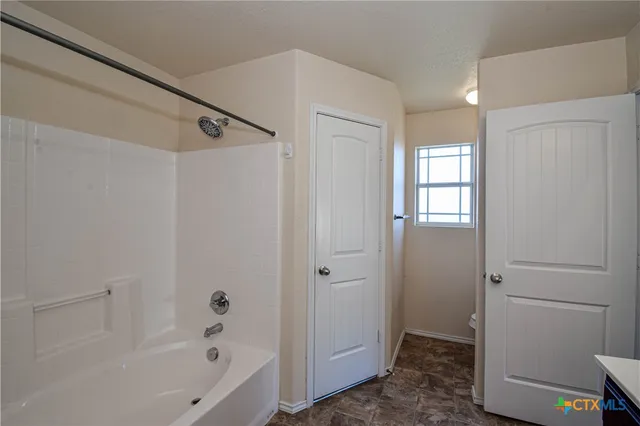 a bathroom with a sink double vanity tub and a mirror
