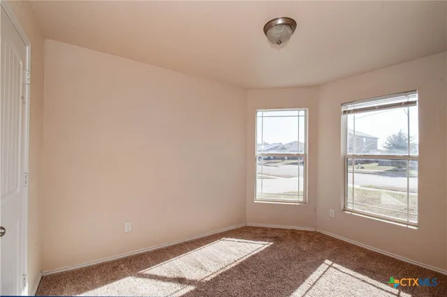 a view of an empty room with a fireplace