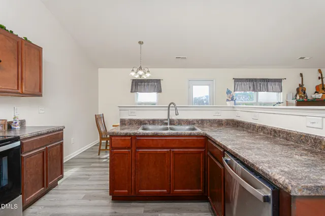 a kitchen with granite countertop a sink and cabinets