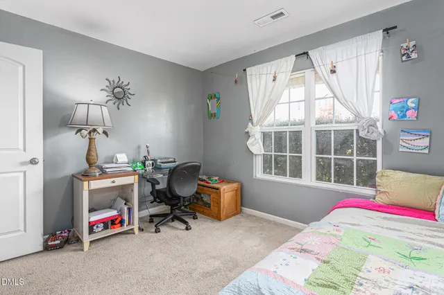 a bedroom with bed and a window