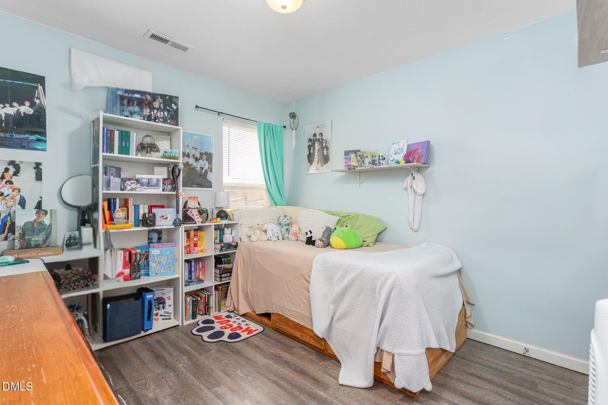 1985 Softwinds Drive Graham, NC 27253 - Photo 19 of 31 a bedroom with a bed and wooden floor