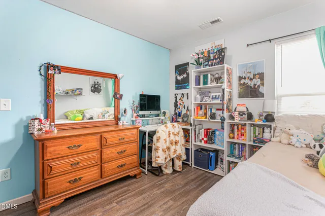a room with furniture a flat screen tv and a book shelf