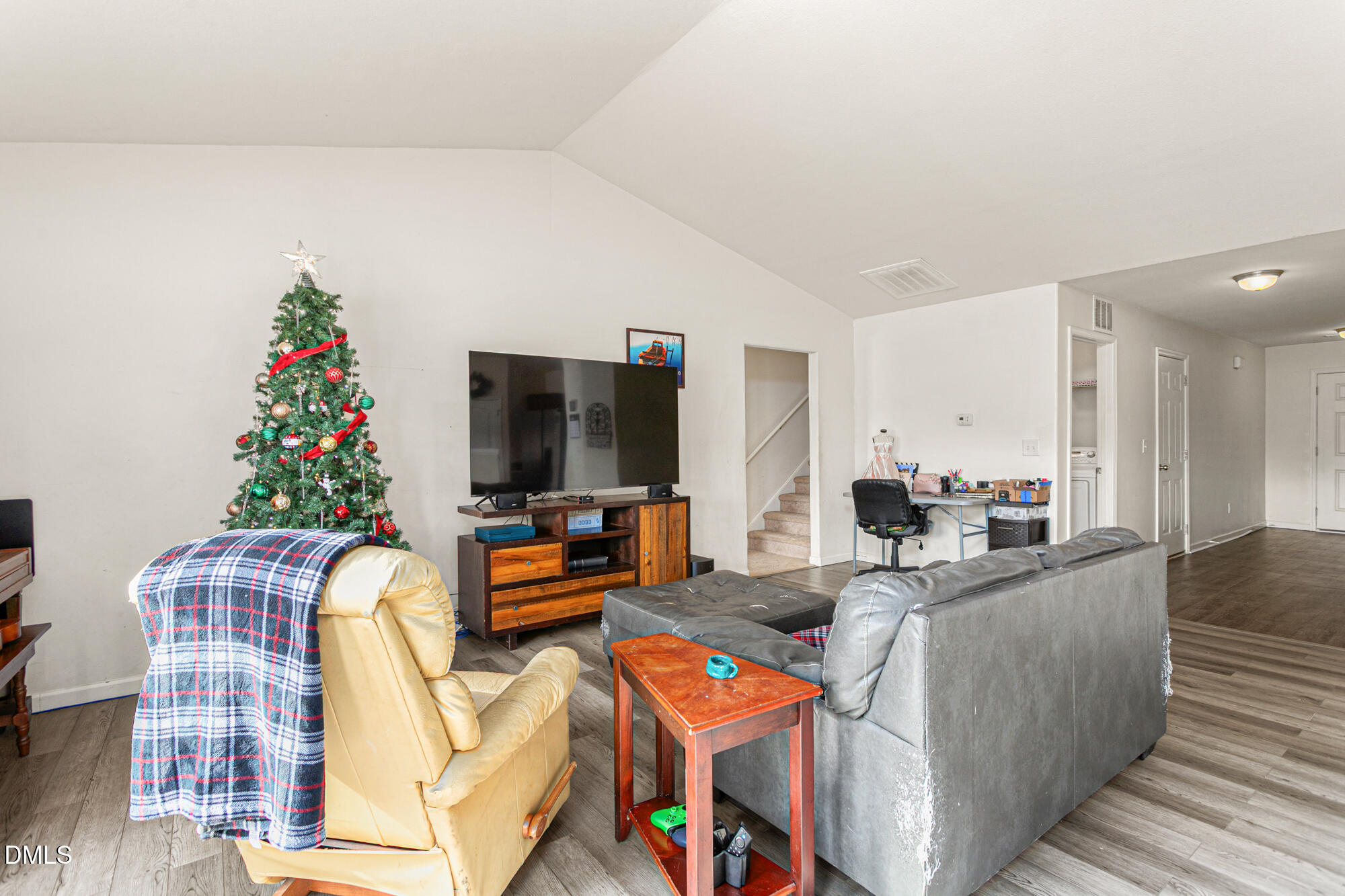 1985 Softwinds Drive Graham, NC 27253 - Photo 6 of 31 a living room with furniture a flat screen tv and a potted plant
