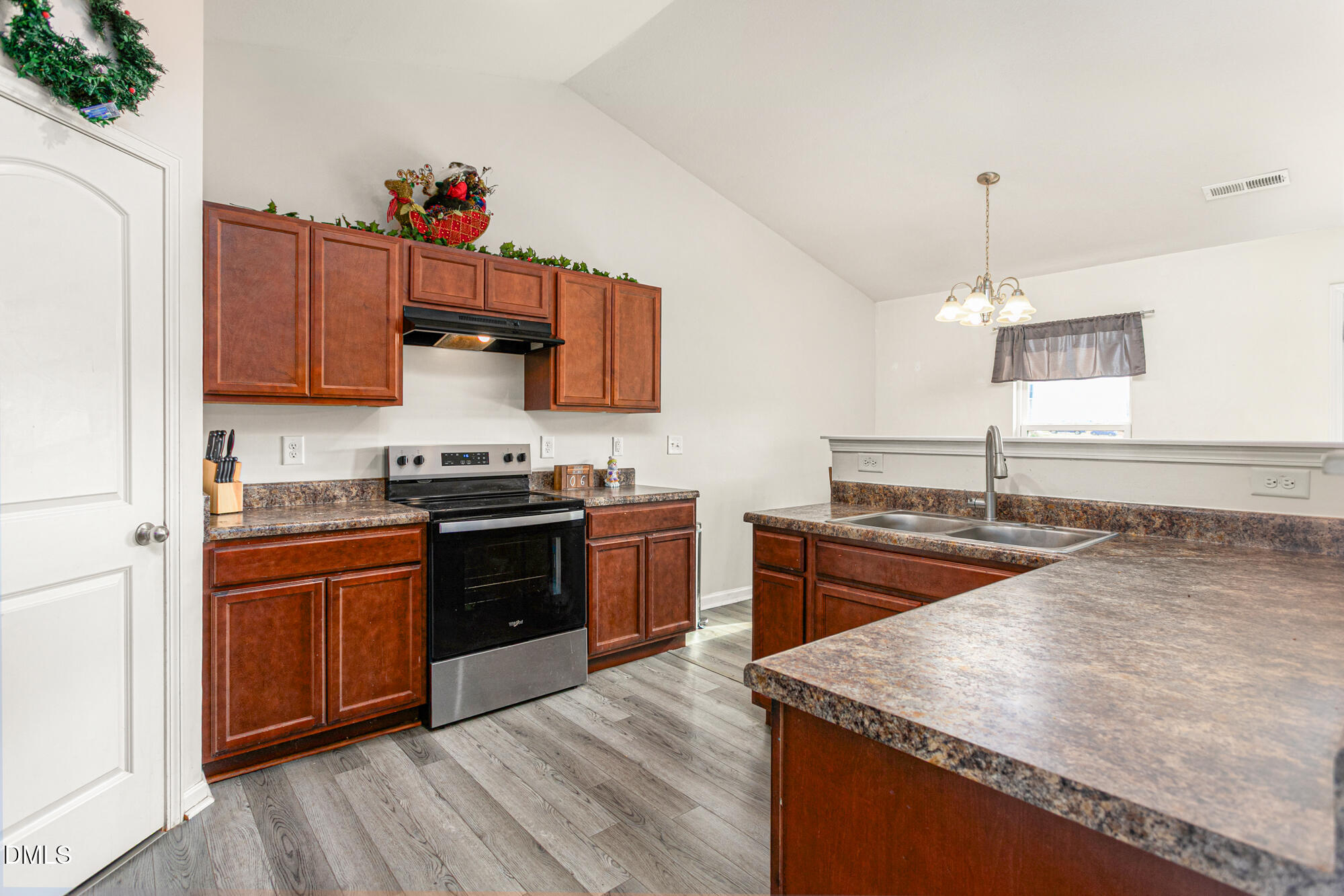 1985 Softwinds Drive Graham, NC 27253 - Photo 8 of 31 a kitchen with stainless steel appliances granite countertop a stove a sink and a microwave