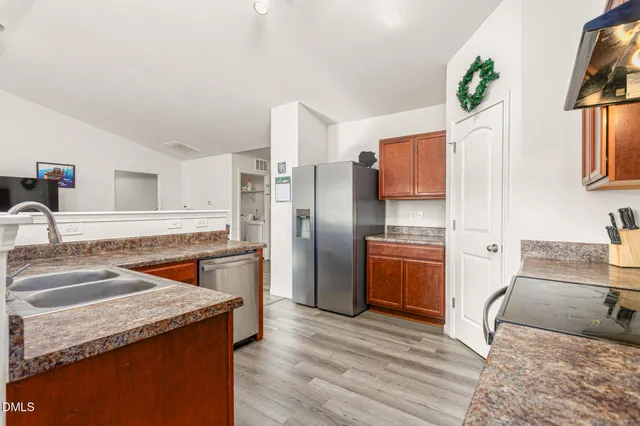 a kitchen with stainless steel appliances granite countertop a sink stove and refrigerator