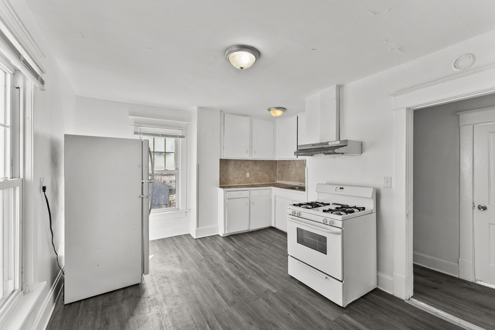 615 44th Street Rock Island, IL 61201 - Photo 13 of 22 a kitchen with stainless steel appliances a white stove top and wooden floors