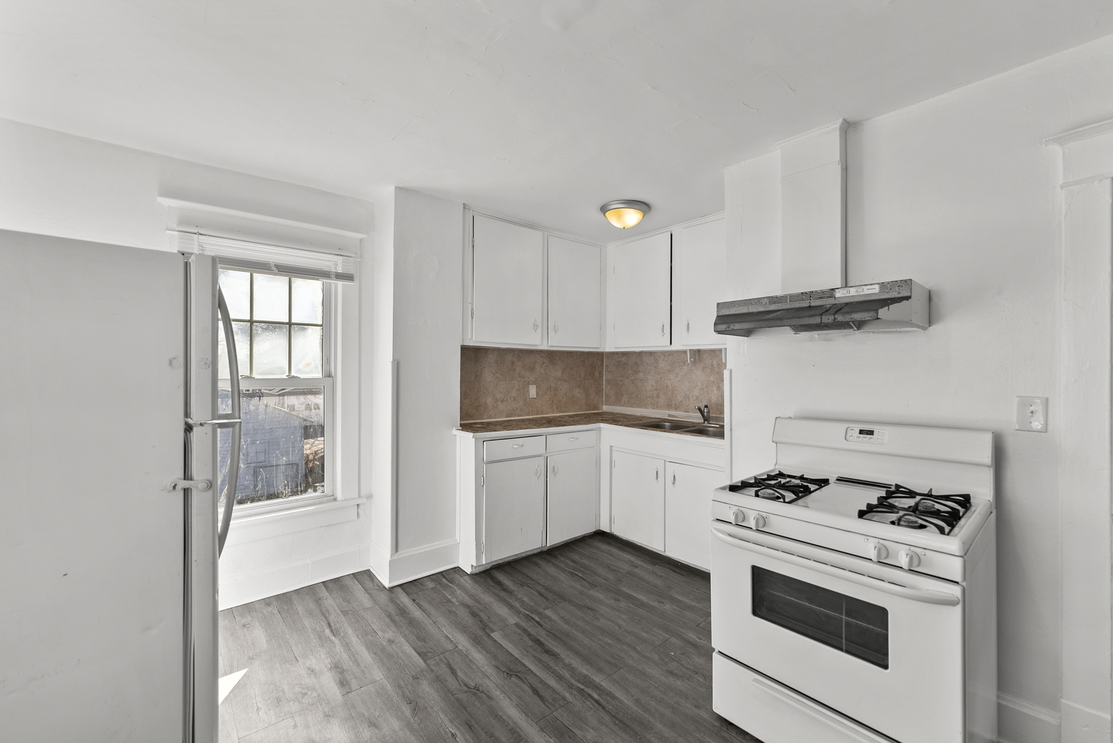 615 44th Street Rock Island, IL 61201 - Photo 14 of 22 a kitchen with a stove and a refrigerator