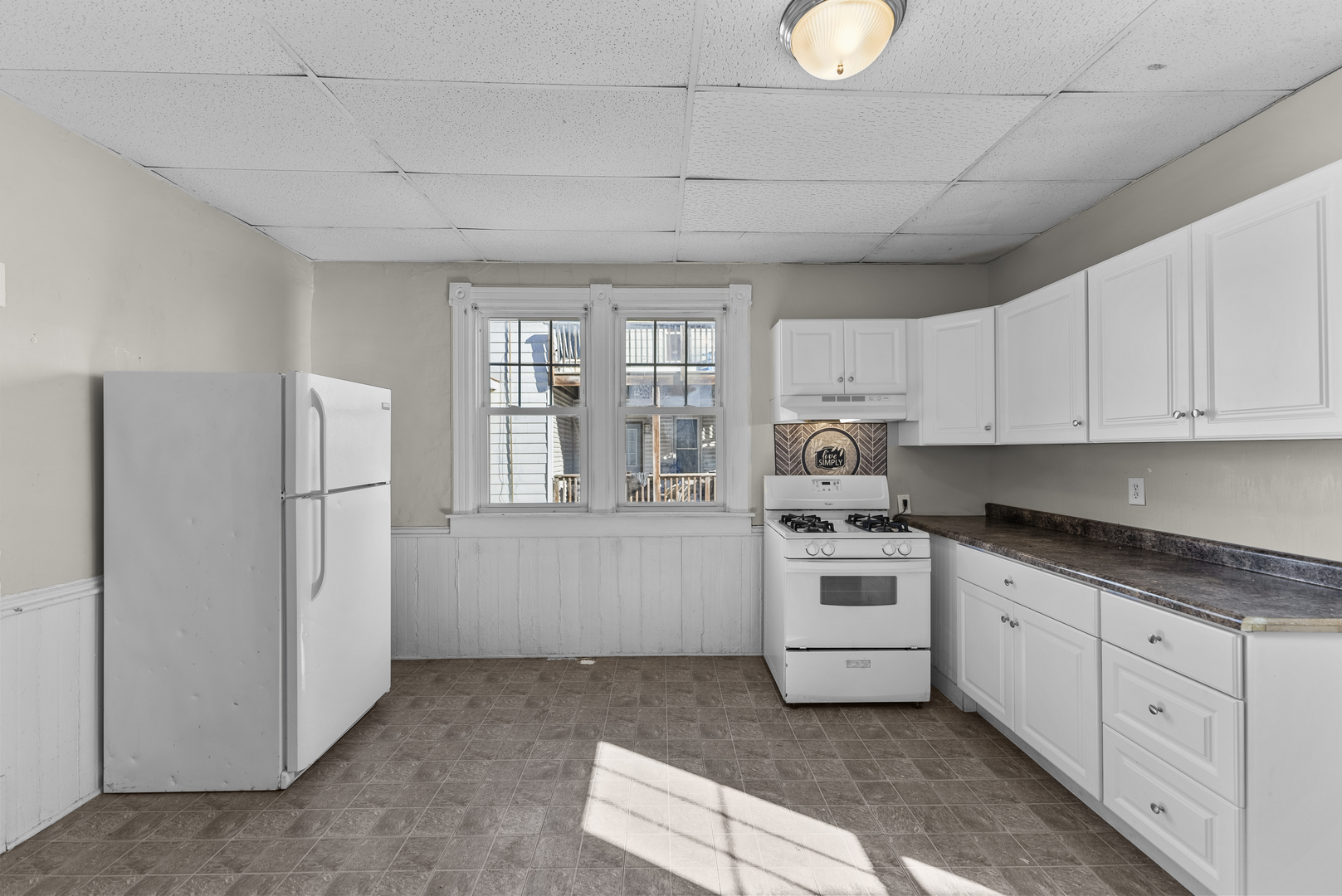 615 44th Street Rock Island, IL 61201 - Photo 2 of 22 a kitchen with white cabinets and white appliances