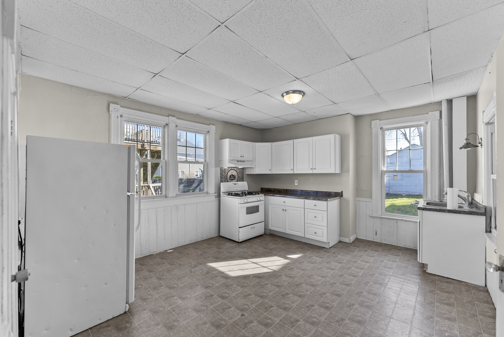 615 44th Street Rock Island, IL 61201 - Photo 3 of 22 a kitchen with a refrigerator and a stove top oven