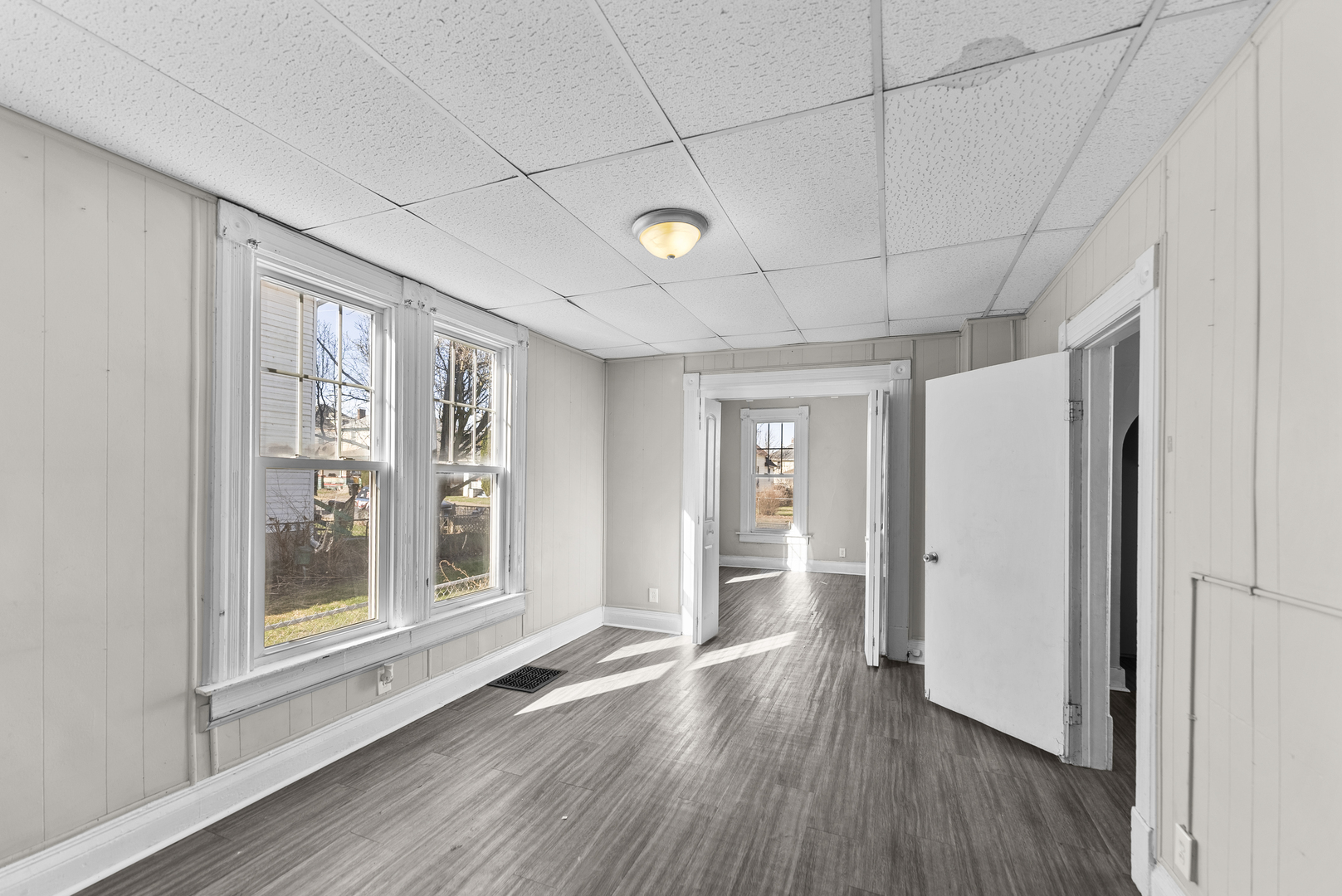 615 44th Street Rock Island, IL 61201 - Photo 5 of 22 a view of an empty room with window and wooden floor