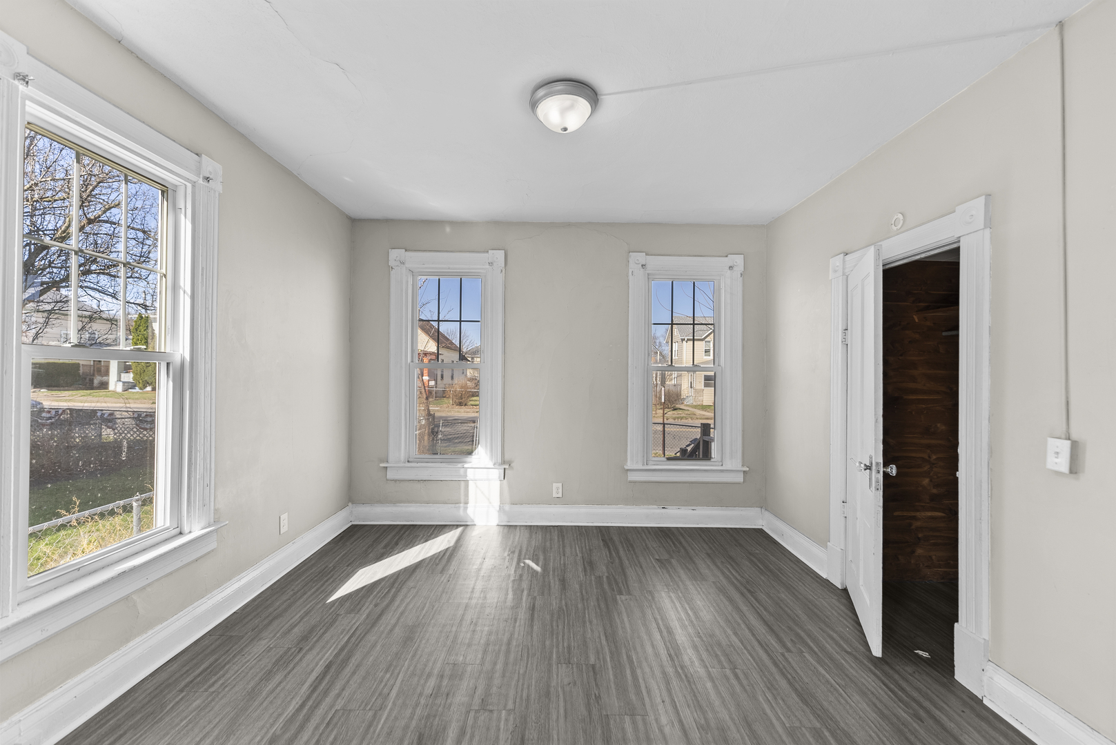 615 44th Street Rock Island, IL 61201 - Photo 6 of 22 wooden floor in an empty room with a window
