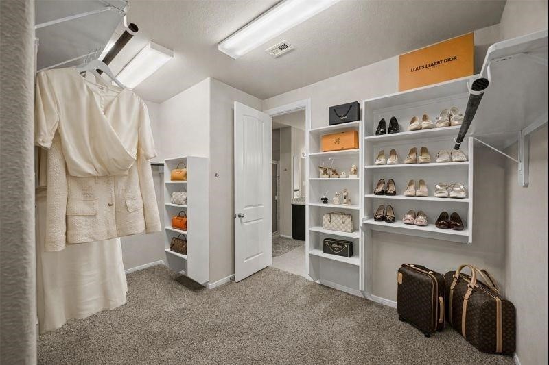 4438 Selwyn Road Richmond, TX 77407 - Photo 12 of 23 a view of walk in closet with clothes and shoes
