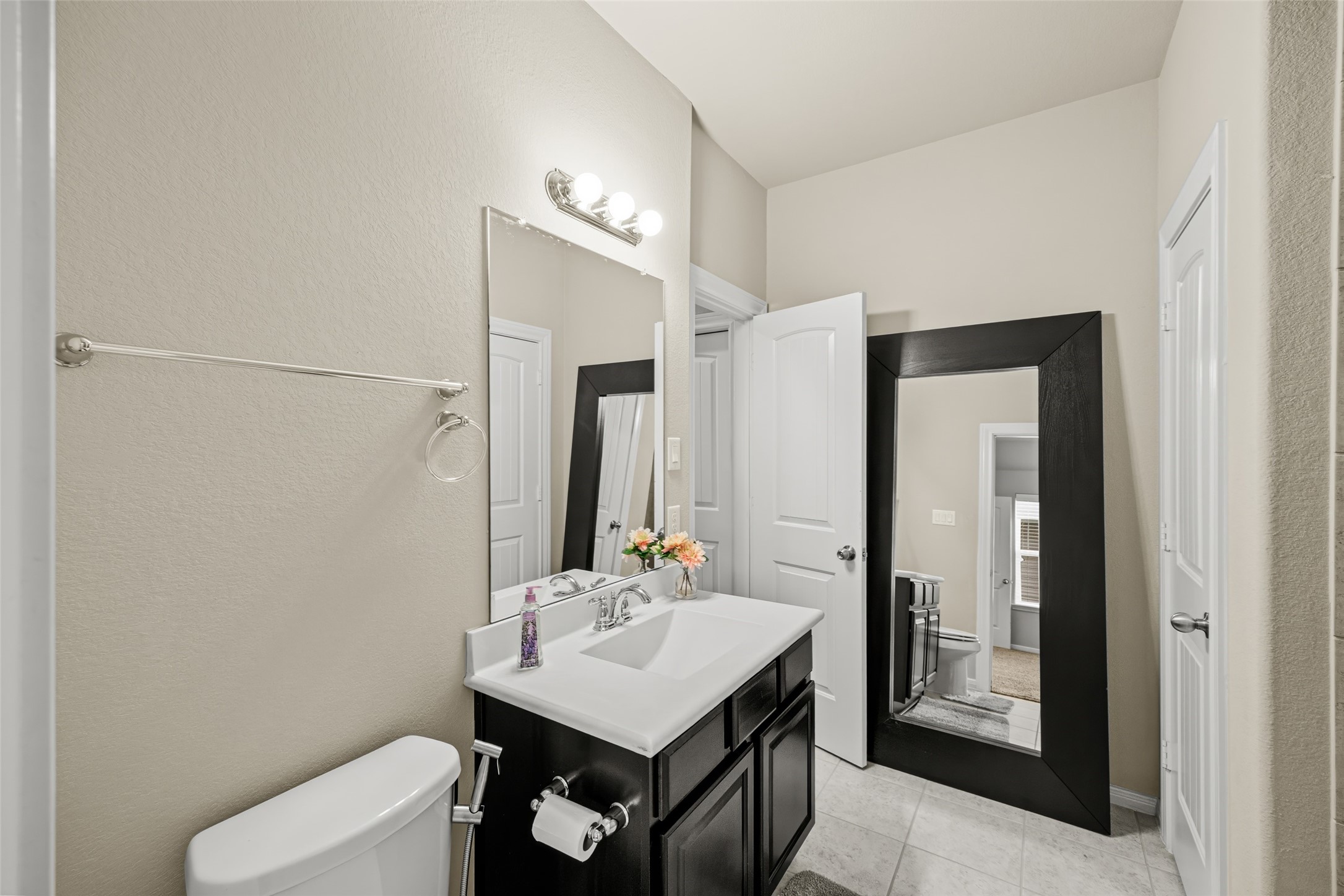 4438 Selwyn Road Richmond, TX 77407 - Photo 20 of 23 a bathroom with a sink vanity and a mirror