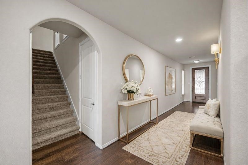 4438 Selwyn Road Richmond, TX 77407 - Photo 3 of 23 a view of a hallway with entryway wooden floor and front door