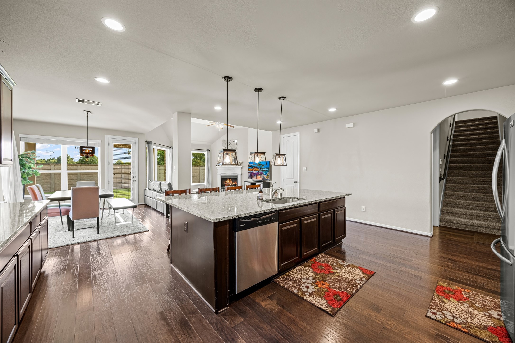 4438 Selwyn Road Richmond, TX 77407 - Photo 6 of 23 a large kitchen with stainless steel appliances granite countertop a stove and a wooden floors
