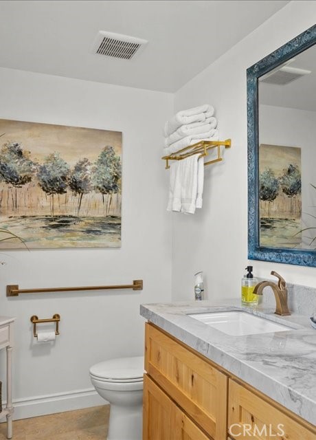 701 Rio Street Red Bluff, CA 96080 - Photo 17 of 73 a bathroom with a granite countertop sink a toilet and a mirror