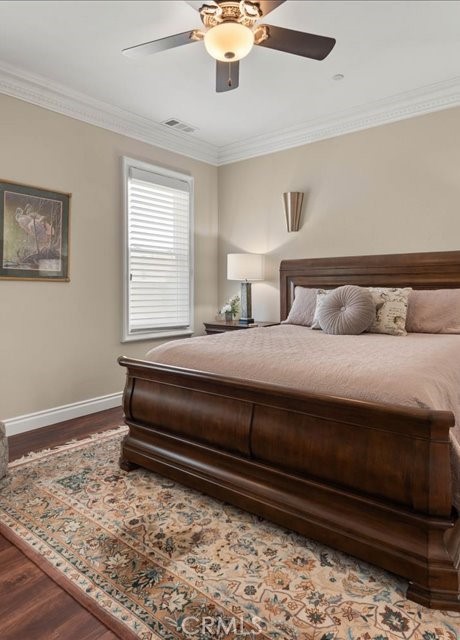 701 Rio Street Red Bluff, CA 96080 - Photo 63 of 73 a bedroom with a bed and wooden floor