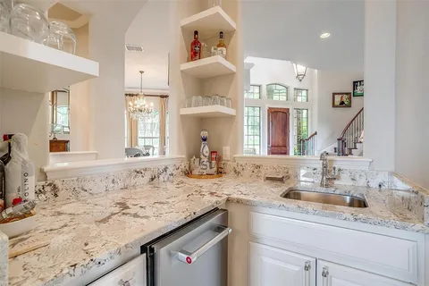 a living room with furniture a rug and white walls