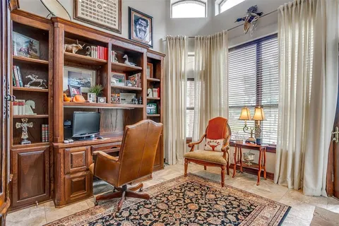 a bedroom with a bed a lamp and window