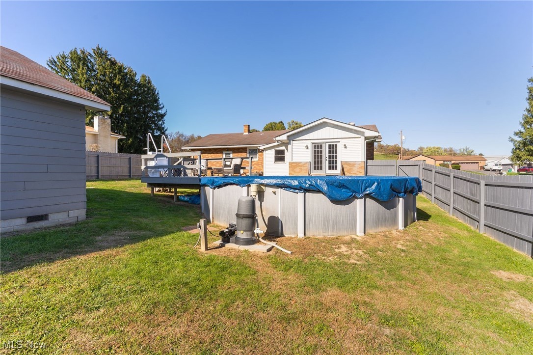 1230 Parshall Road Wellsville, OH 43968 - Photo 40 of 42 Back of house featuring a yard and a swimming pool side deck