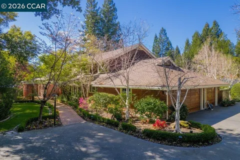 a view of a house with a yard and garden