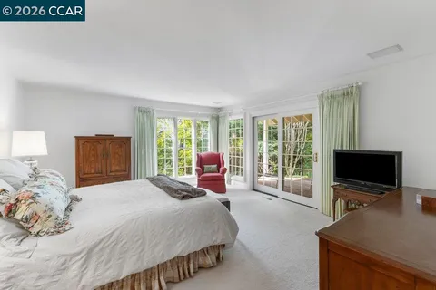 a bedroom with a bed and a flat screen television